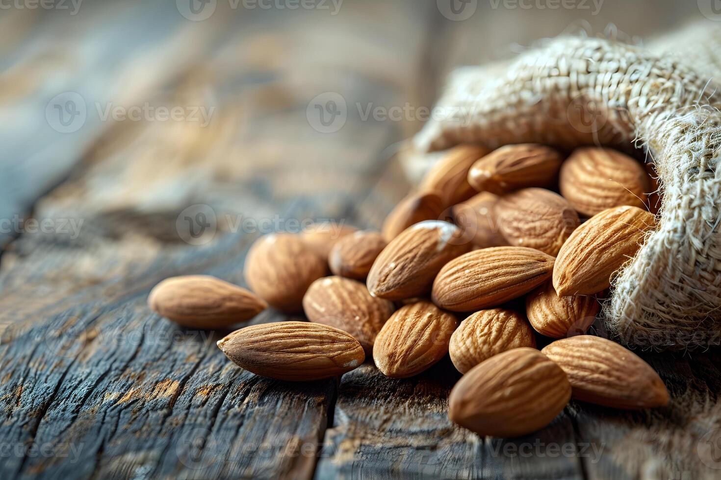 Rustic Burlap Sack of Almonds on Wooden Table for Natural Food and Diet Concepts photo