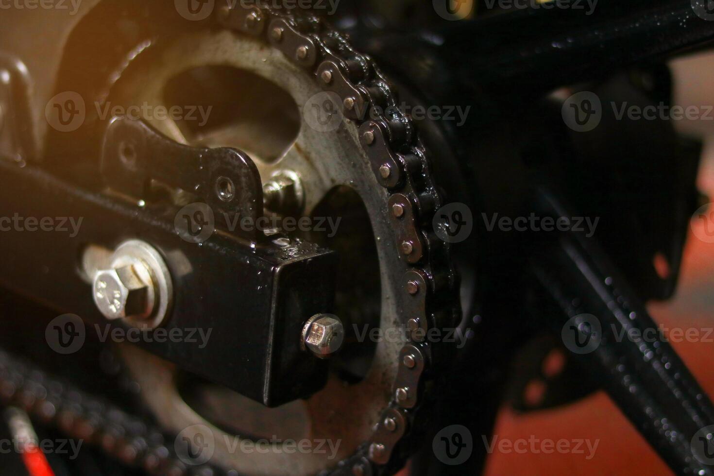 Close-up of the chain and gears of a motorcycle. Selective focus. photo