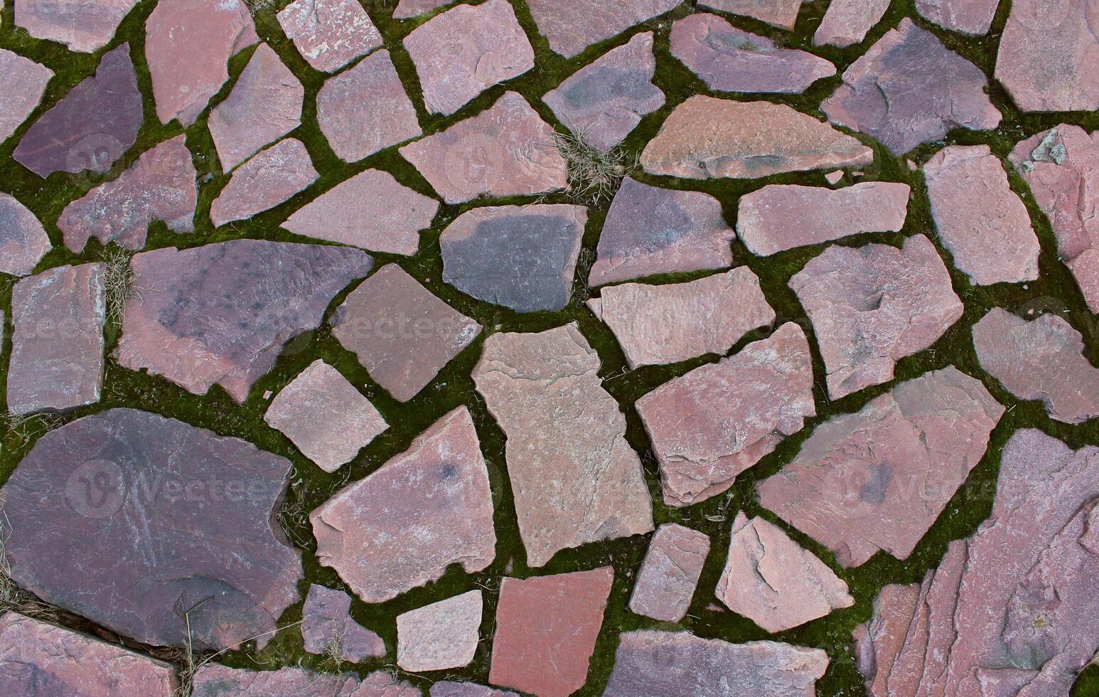 Ancient walking path paved with red granite with straight edges photo