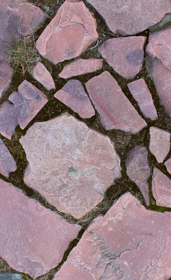 Detailed pattern of red stones in ancient basement stock photo for vertical backgrounds
