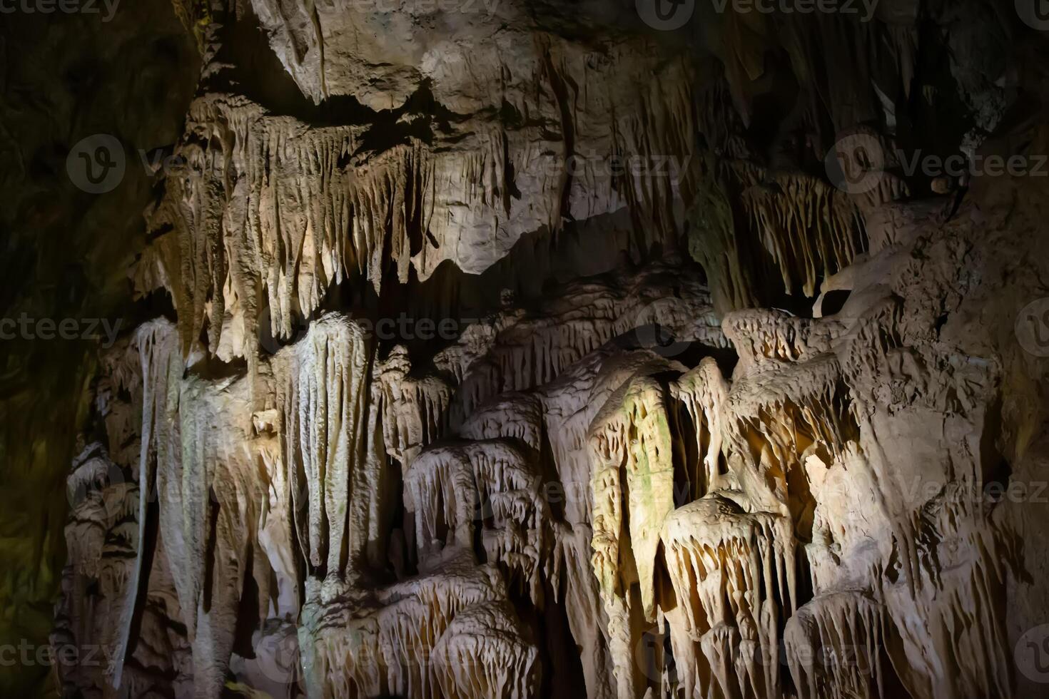 The cave is karst, amazing view of stalactites and stalagnites illuminated by bright light, a beautiful natural attraction in a tourist place. photo