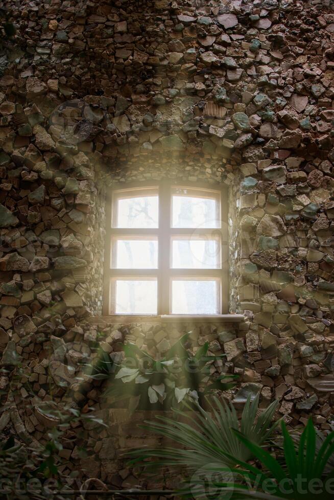 Rays of sunlight from the windows of an ancient stone building. photo