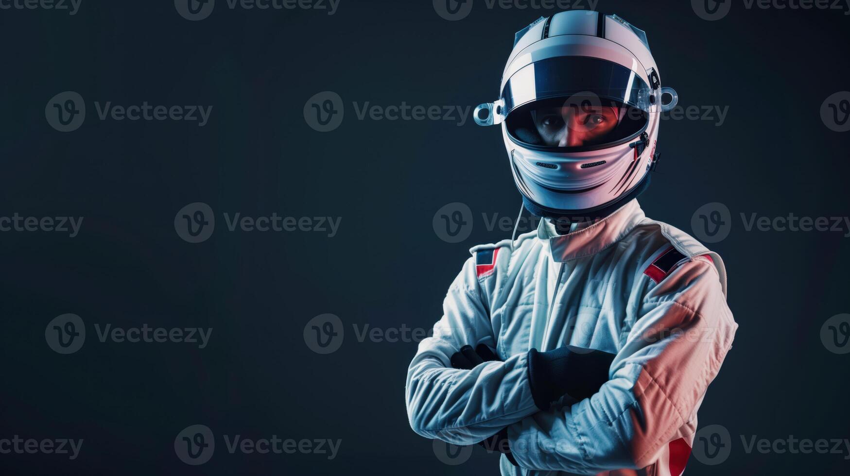 Professional Racing Driver in Full Race Suit and Helmet Standing with Arms Crossed in Studio Shot photo