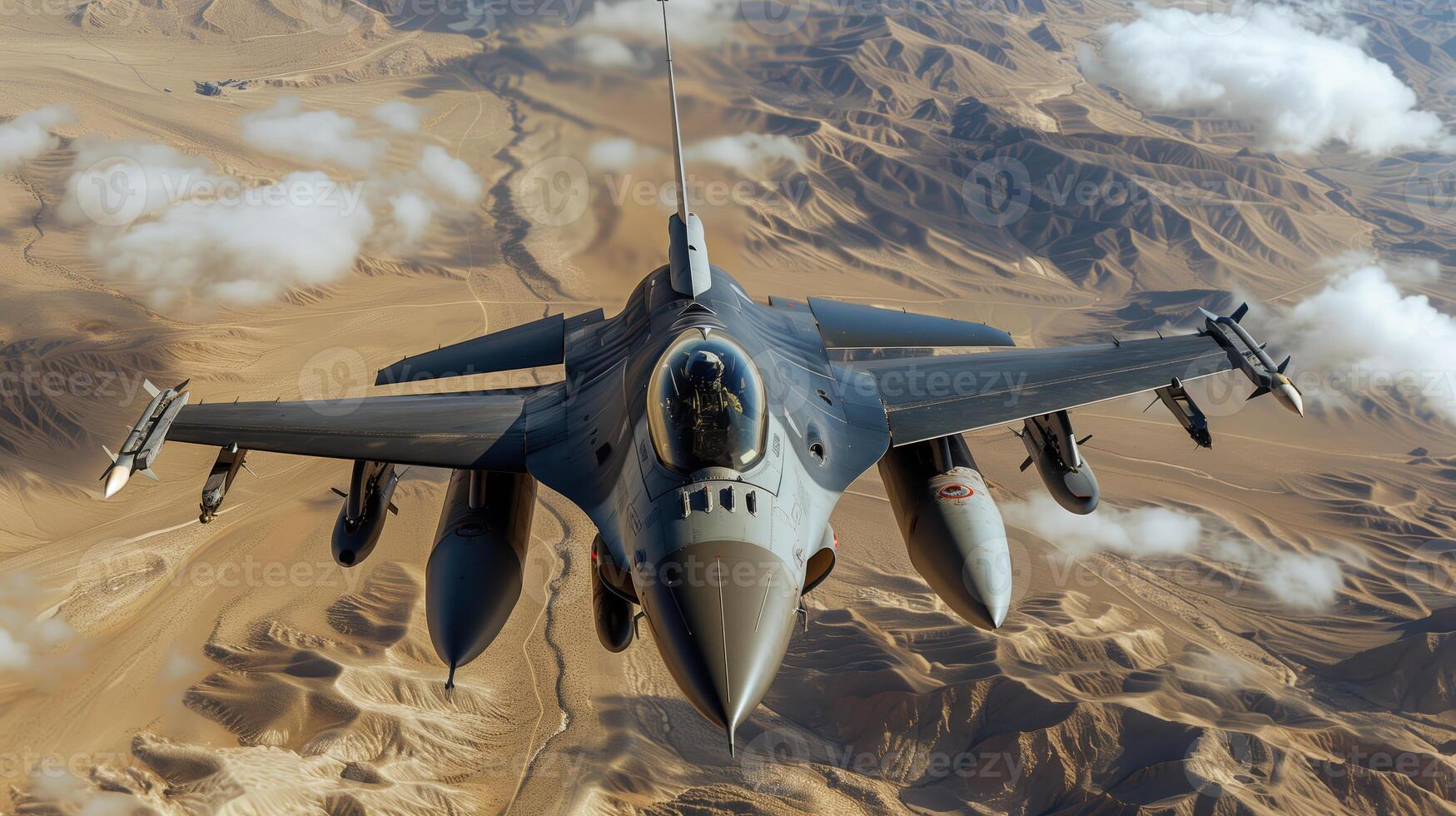 F16 Fighter Jet Soaring Above Desert Landscape with Clouds and Mountains photo