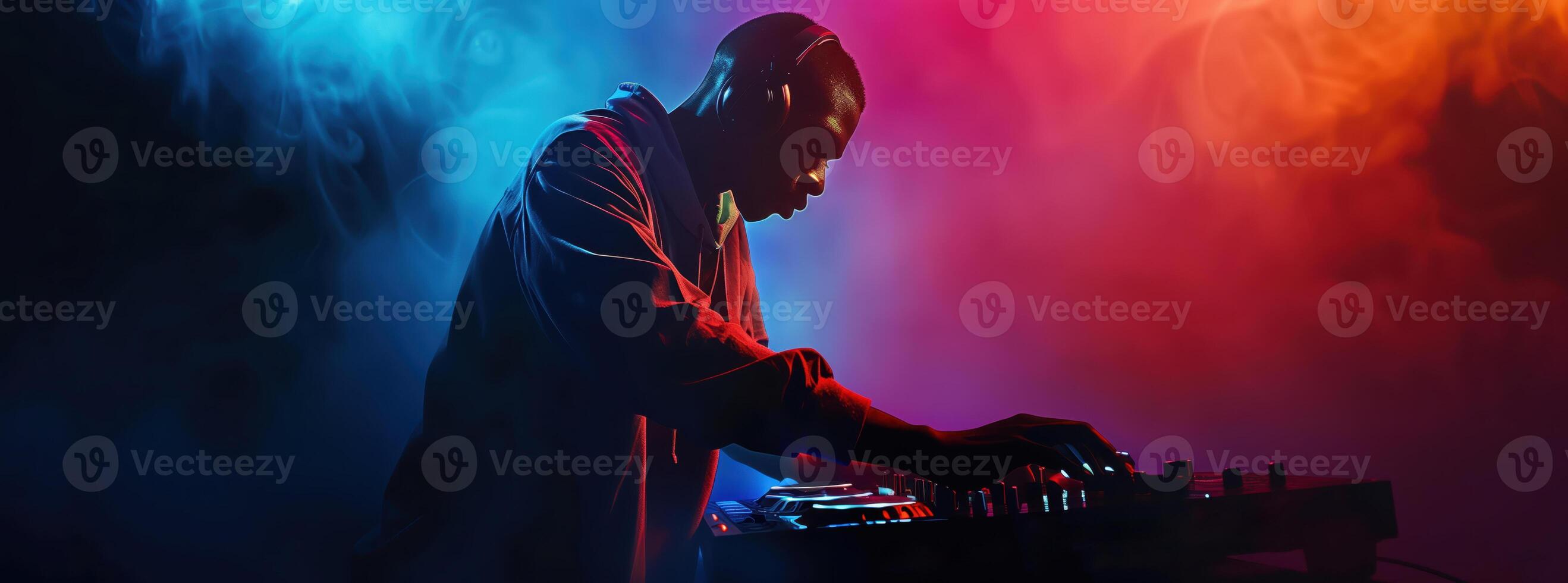DJ Playing Music at a Nightclub with Dynamic Lighting and Colorful Smoke Effects photo