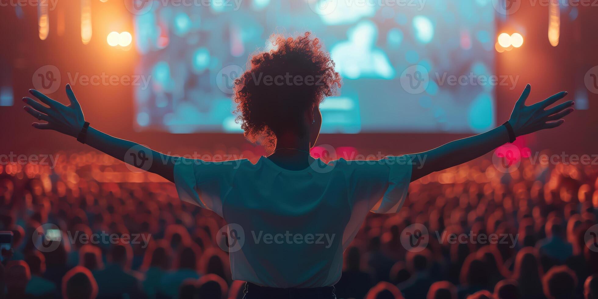 Inspiring Woman Leading a Technology Seminar with Enthusiasm and Confidence in Front of a Large Audience photo