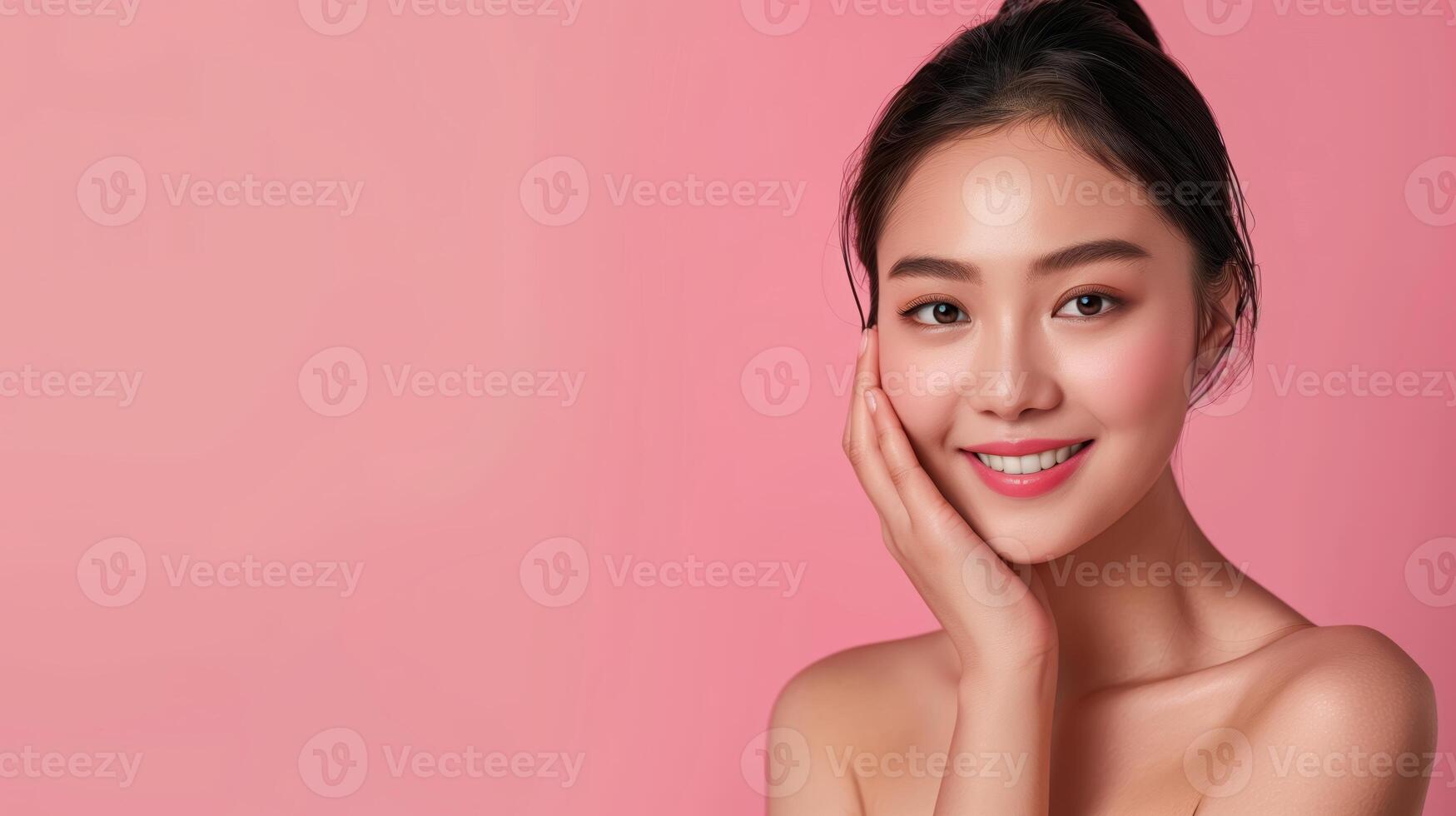 Beautiful Woman Embracing Skincare Routine with Radiant Smile on Soft Pink Background photo