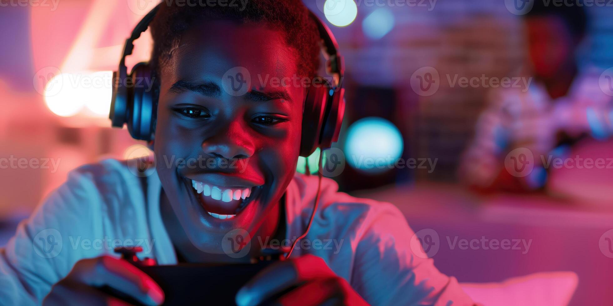 Joyful Teenage Boy Gaming with Headphones, Smiling and Cheering in a Colorful Room photo