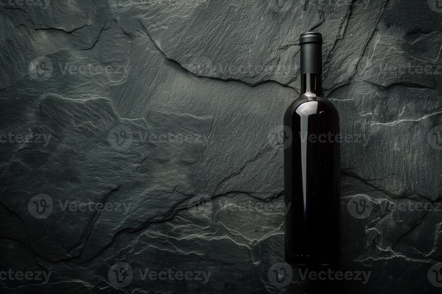 Dark Wine Bottle on Textured Slate Surface with Subtle Light Spot Creating Elegant and Sophisticated Mood photo