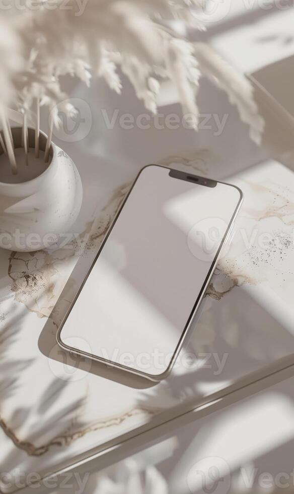 White Minimalist Smartphone Mockup on a Marble Desk with Elegant Decor in Natural Sunlight photo