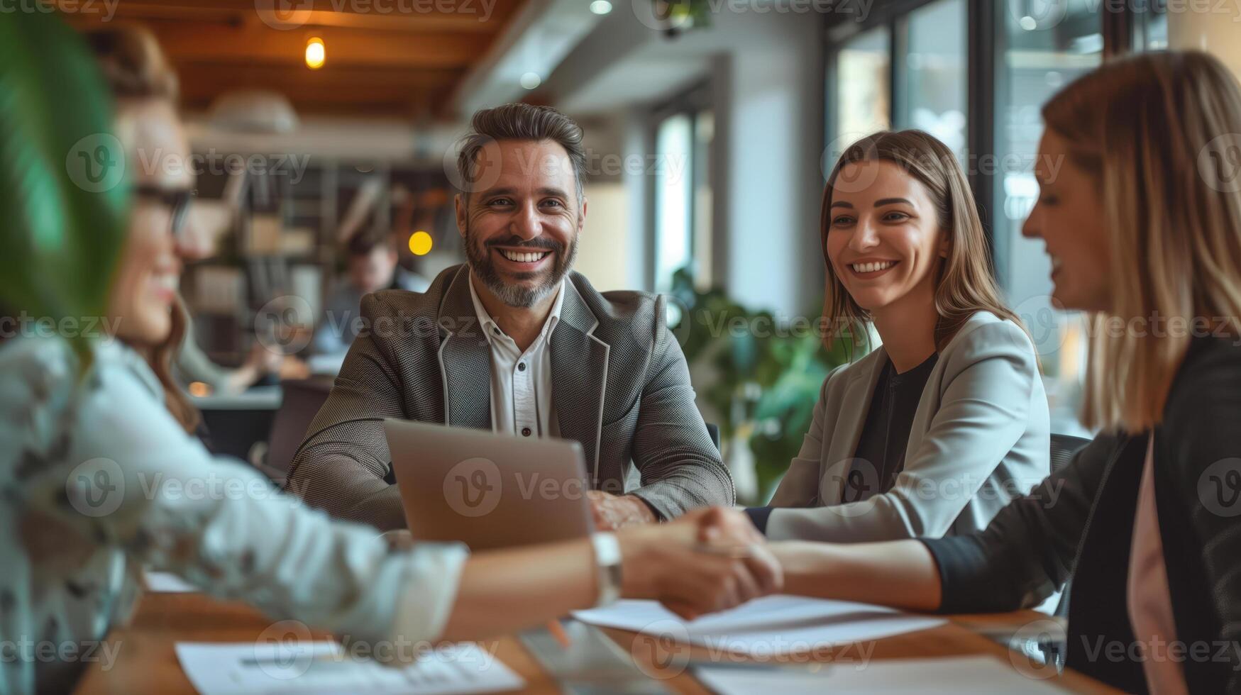 Professional Team Meeting in a Modern HR Office with Smiling Business Executives Collaborating Around a Table photo