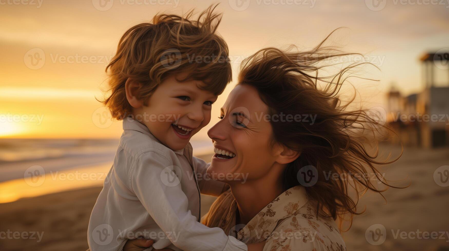 Mother and Son Smiling at Sunset on the Beach, Embracing and Enjoying Moment photo