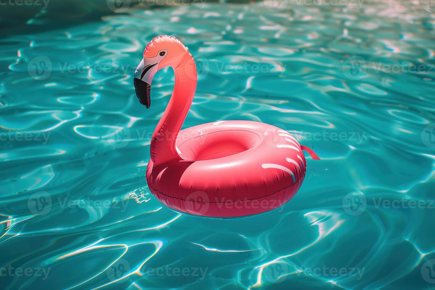 Inflatable Pink Flamingo Float in a Sparkling Blue Swimming Pool photo