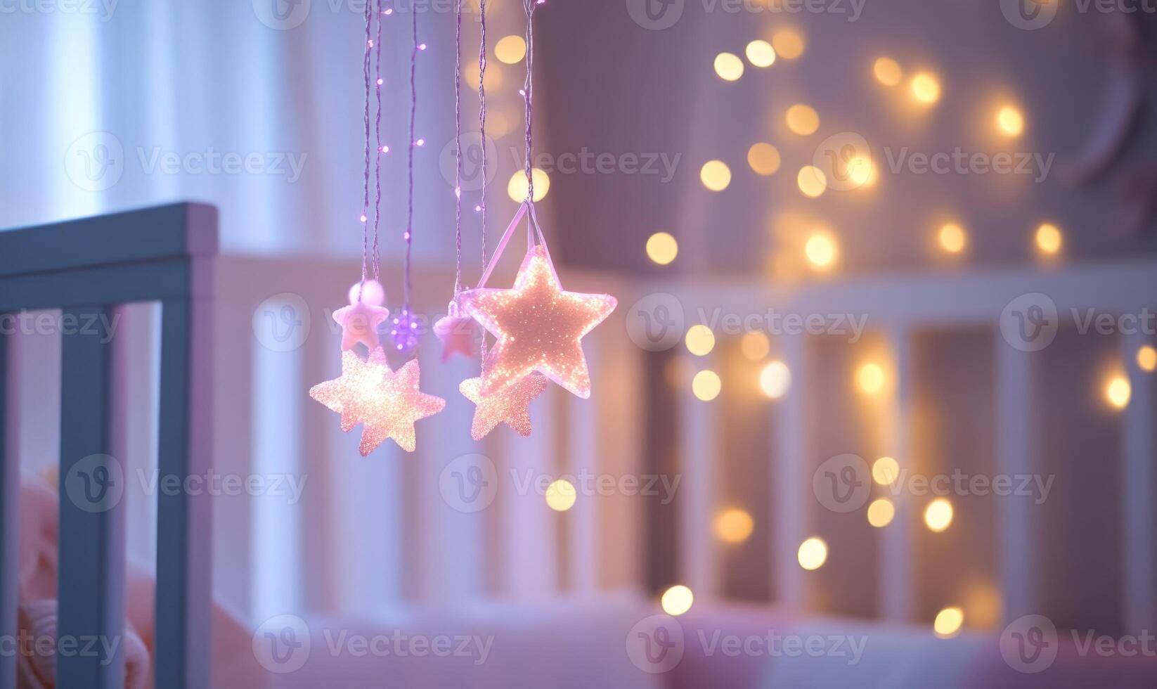 White crib with starry mobile photo