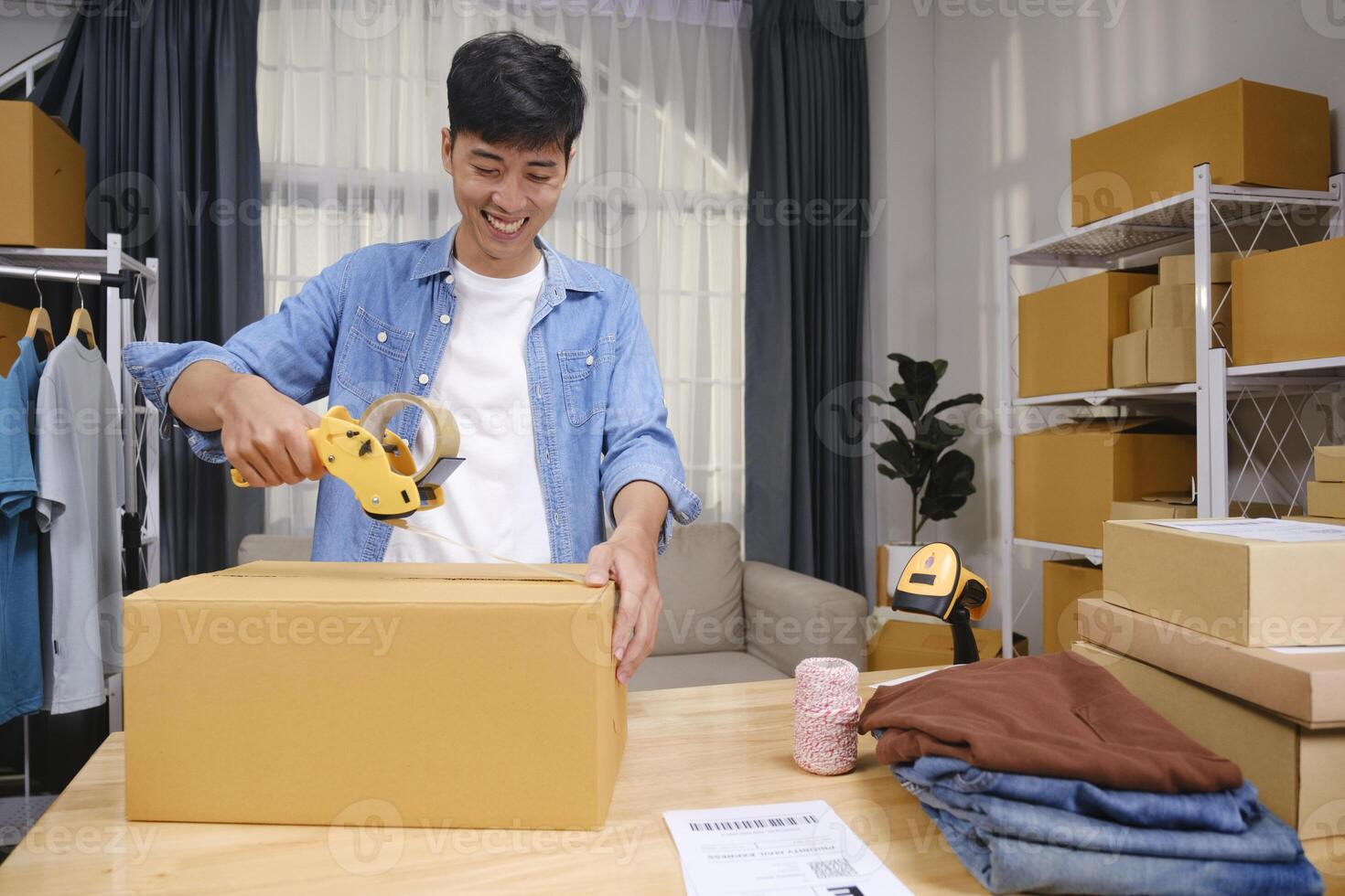 Young business owner working and selling online product and prepare packaging process at office for the order of customer. Online small business concept. photo