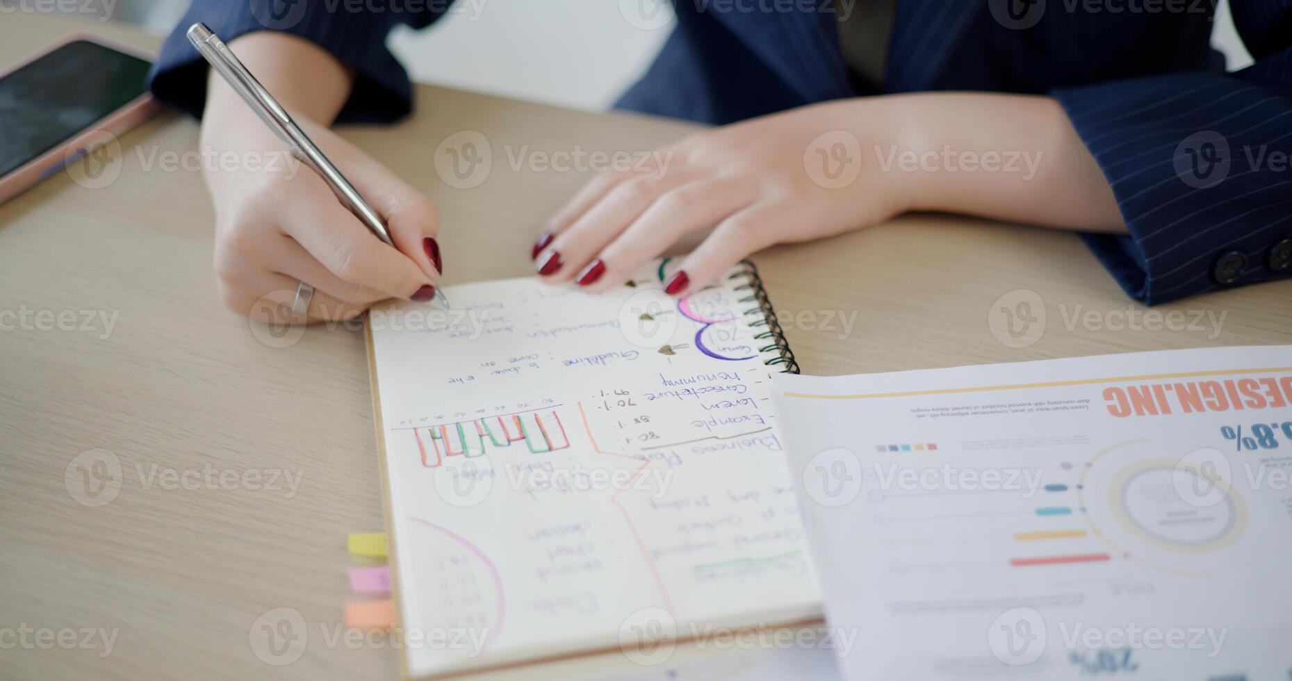 Selective focus, Hands of Asian businesswoman is analyze documents and taking notes in small coffee shop. Work from anywhere, Remote working photo