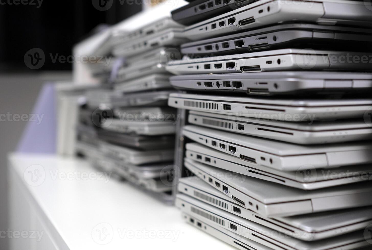 Stack of laptops in the storage room of a company photo