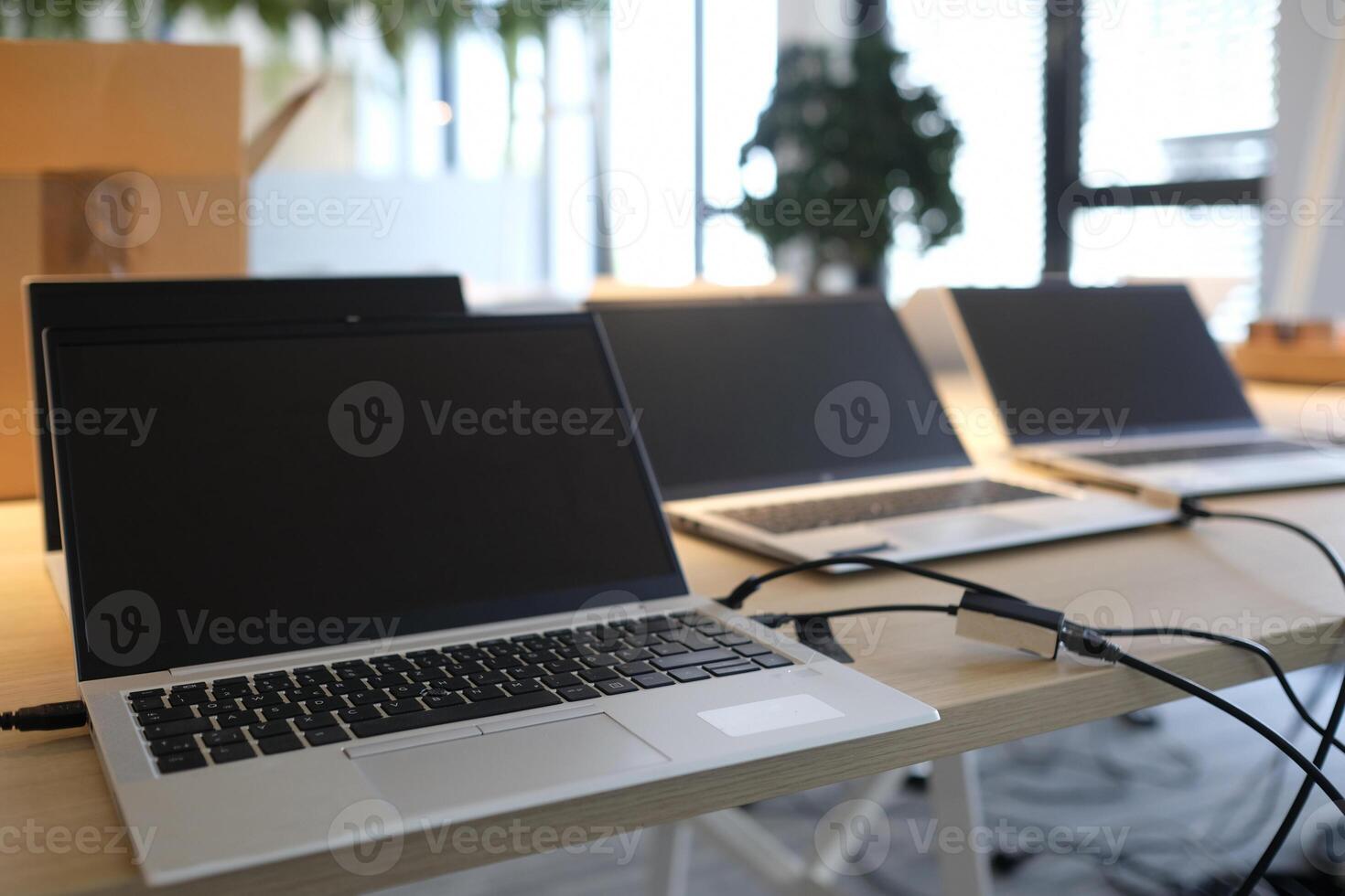 Laptops on a table in an empty co-working space photo