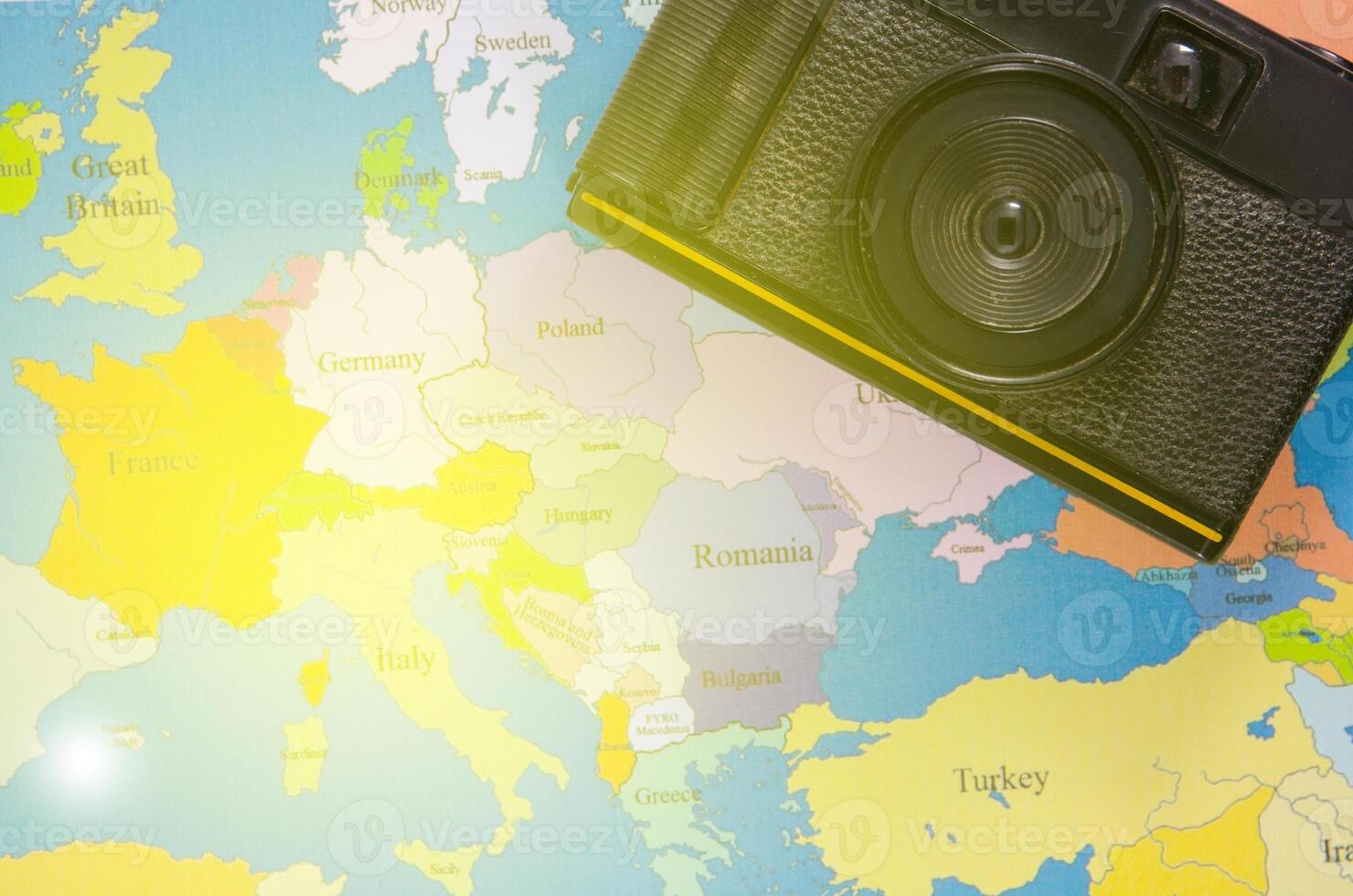 black camera lay on europe map photo