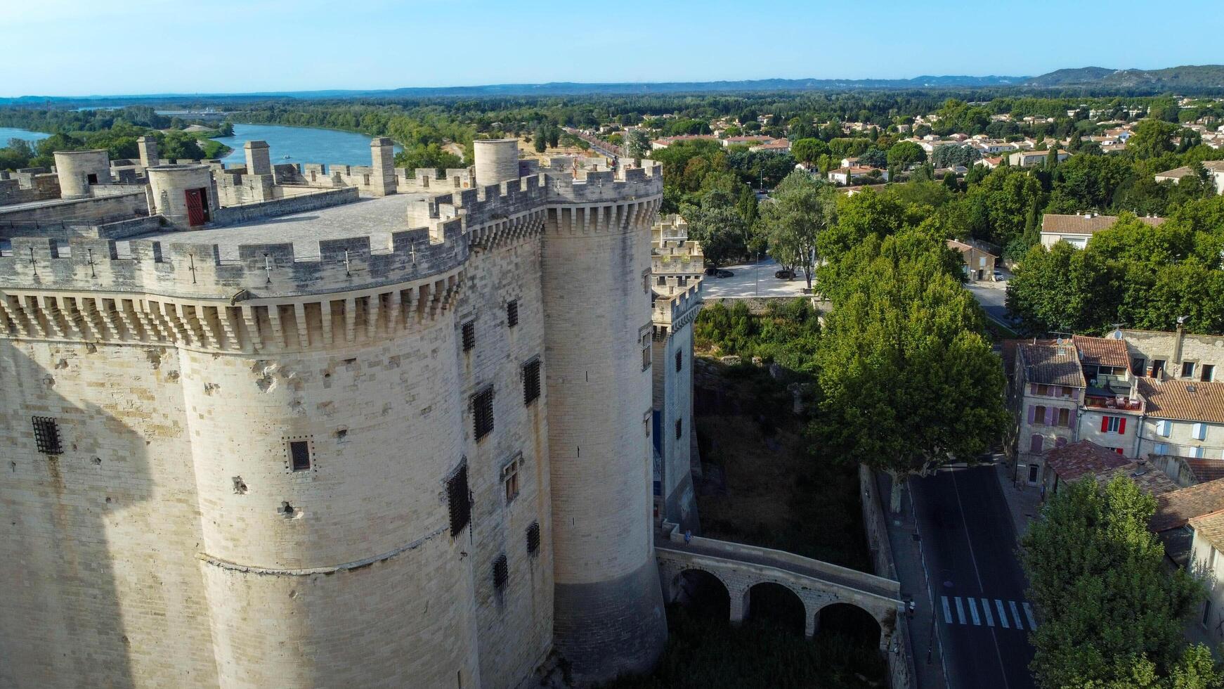Magnificent medieval castle in Tarascon, a French town located in the Bouches-du-Rhone department of the Provence-Alpes-Cote d'Azur. City of Tarascon seen from a drone, tourist travel destination. photo
