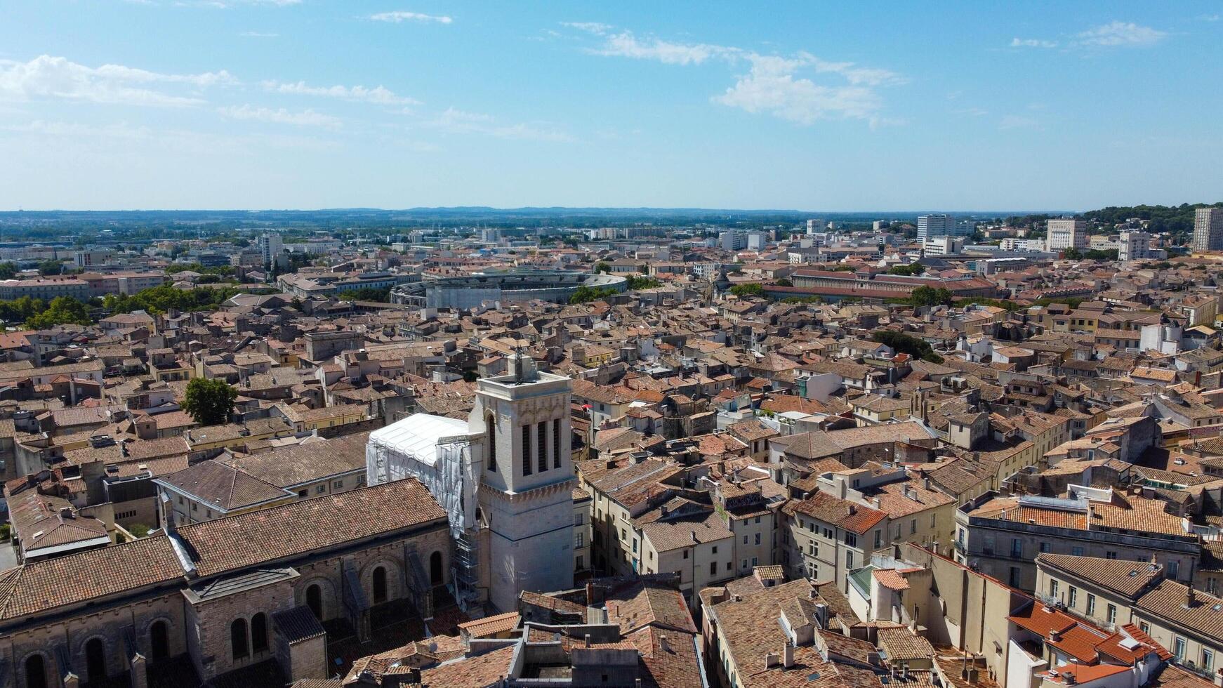 Aerial view of the French city of Nimes with the Eglise Saint-Baudile, Cathedrale Notre-Dame-et-Saint-Castor and the Roman Arena of Nimes. Famous picturesque town located in Provence, France. photo