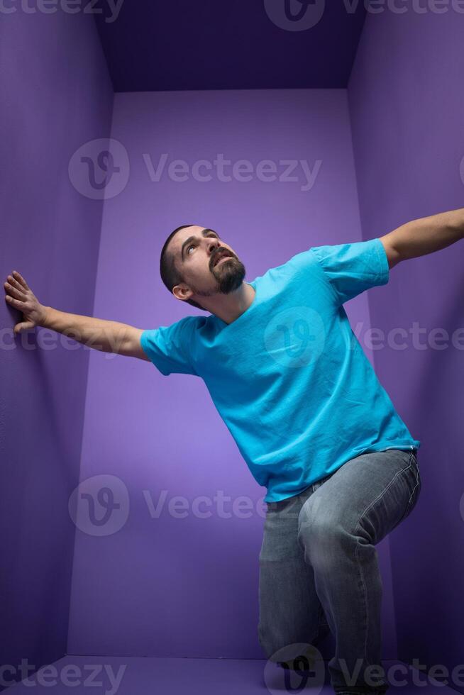 Young man isolated on purple background thinking and looking up. photo