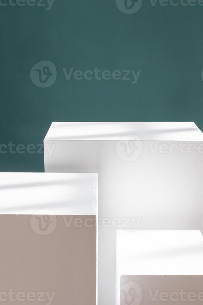 Three white boxes stacked on table, creating shelving like structure for product presentations. photo