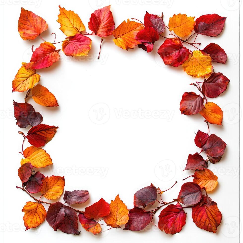 A vibrant autumn wreath made from colorful leaves and red berries arranged on a white background to celebrate the fall season photo