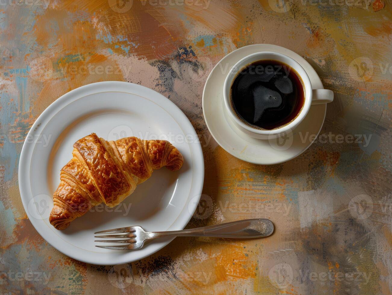 Breakfast croissant and coffee on a rustic table in the morning light photo