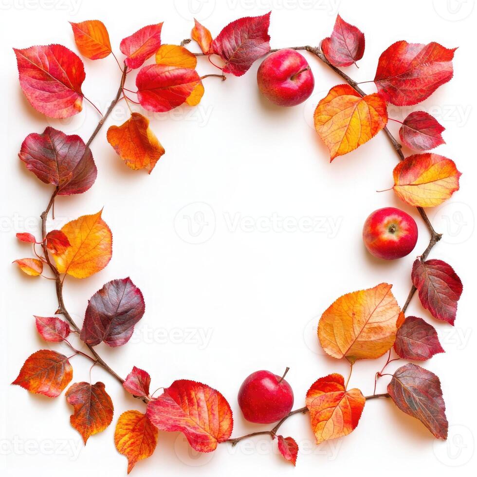 A vibrant autumn wreath made from colorful leaves and red berries arranged on a white background to celebrate the fall season photo