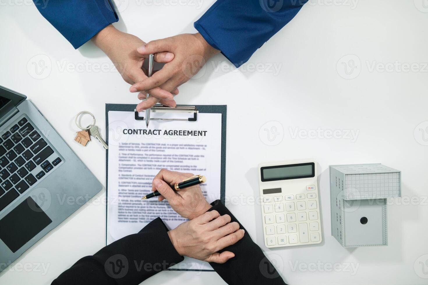 Real estate agent is talking to customer to present promotion for signing contract buy and selling real estate in company project in real estate office. present promotion to make customer decide buy. photo