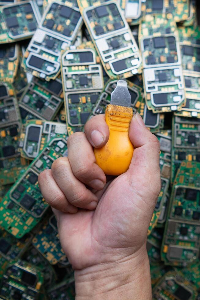 pile of electronic waste on factory floor is circuit board of mobile phone waiting to be processed extract gold to separate precious metal from electronic waste. extracting precious metal from e-waste photo