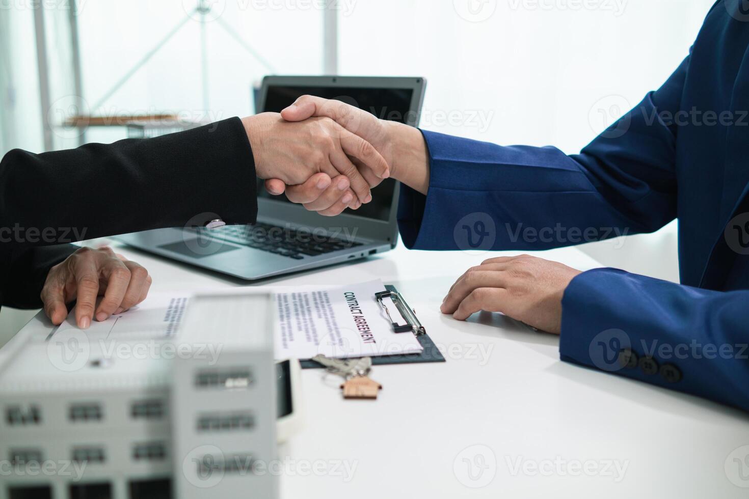 real estate agent shakes hands with customer after agreeing to sign sales contract and signing contract deliver real estate customer. concept of success in agreeing to sign real estate sales contract photo