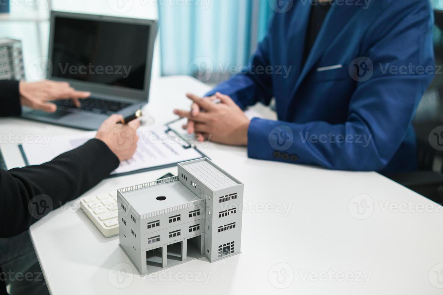 Real estate agent is talking to customer to present promotion for signing contract buy and selling real estate in company project in real estate office. present promotion to make customer decide buy. photo