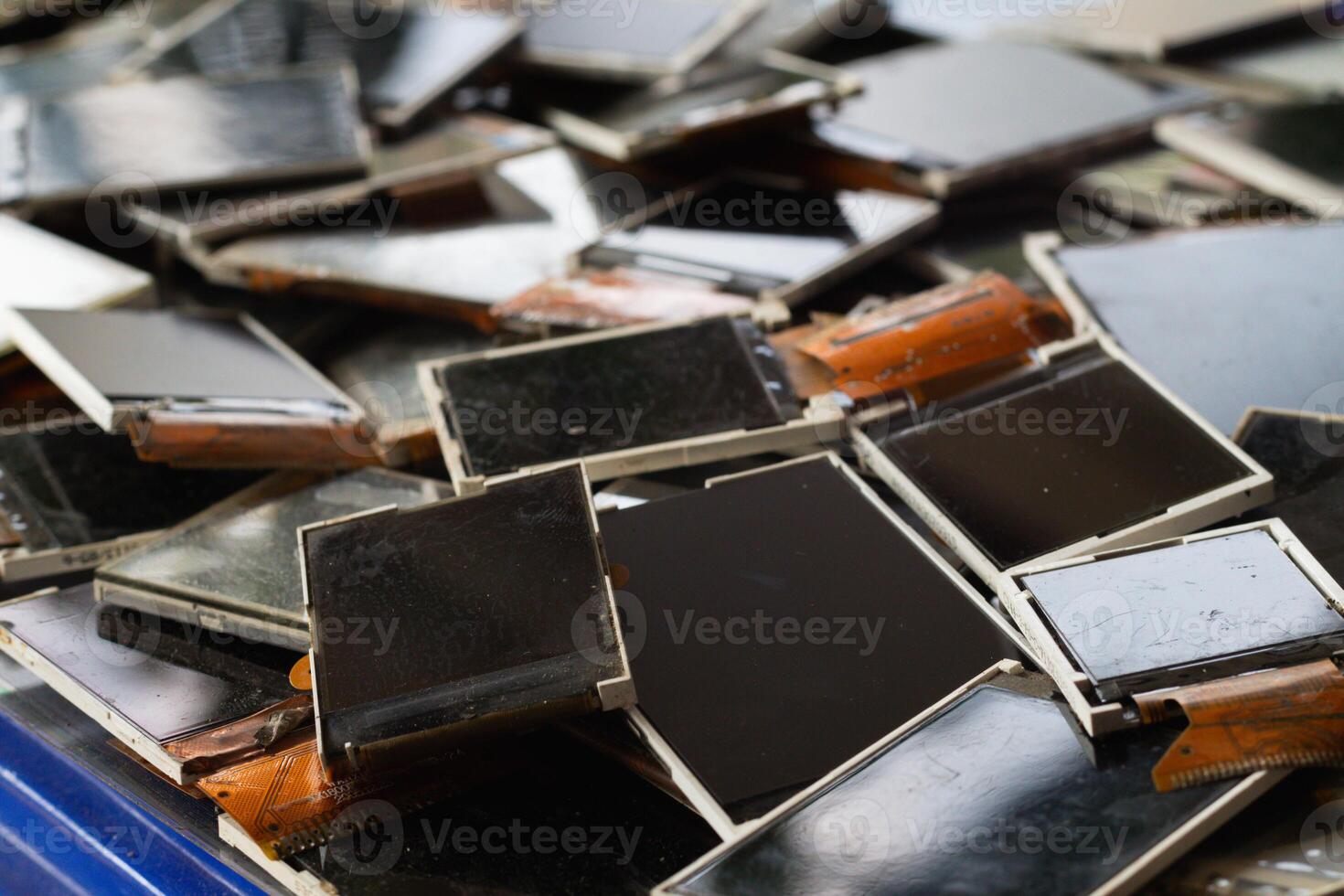 damaged LCD screens of mobile phones are collected as electronic waste waiting for valuable metals inside LCD screens be sorted for reuse reducing e-waste in nature and increasing value of e-waste. photo