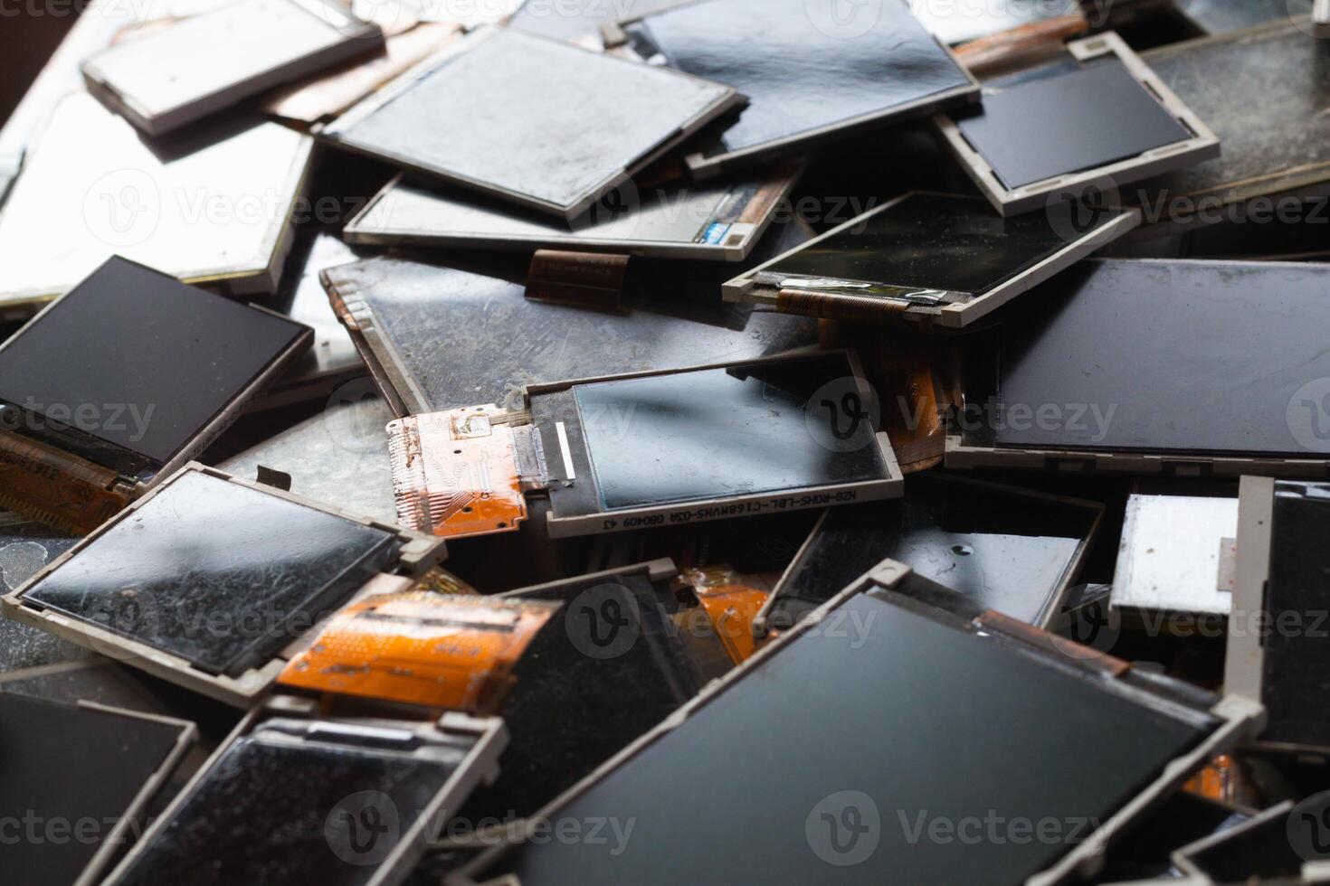 damaged LCD screens of mobile phones are collected as electronic waste waiting for valuable metals inside LCD screens be sorted for reuse reducing e-waste in nature and increasing value of e-waste. photo