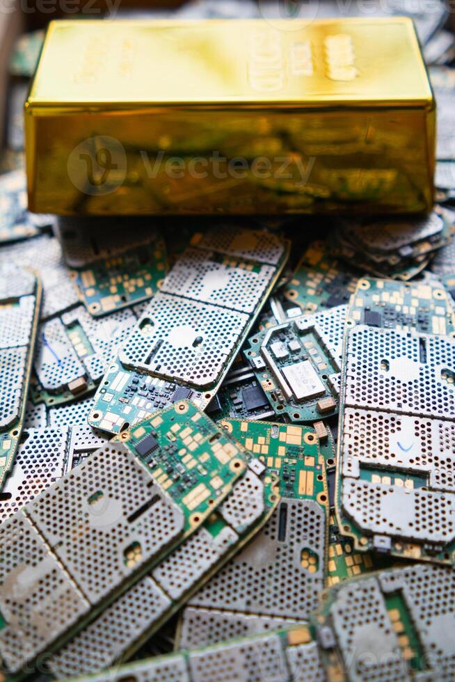 pile of electronic waste on factory floor is circuit board of mobile phone waiting to be processed extract gold to separate precious metal from electronic waste. extracting precious metal from e-waste photo