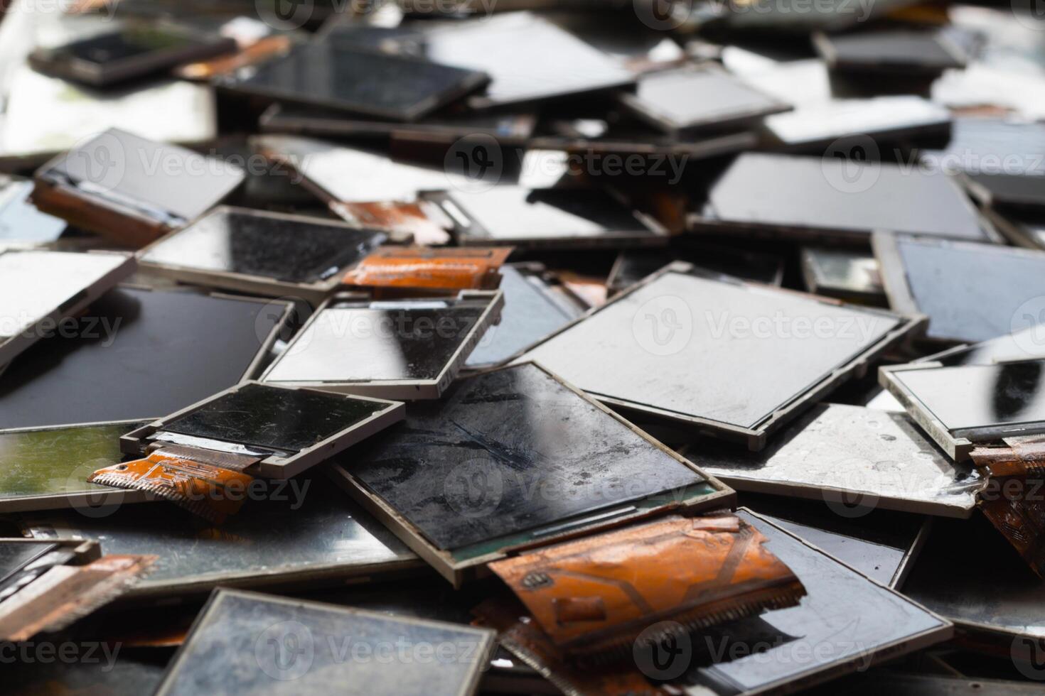 damaged LCD screens of mobile phones are collected as electronic waste waiting for valuable metals inside LCD screens be sorted for reuse reducing e-waste in nature and increasing value of e-waste. photo