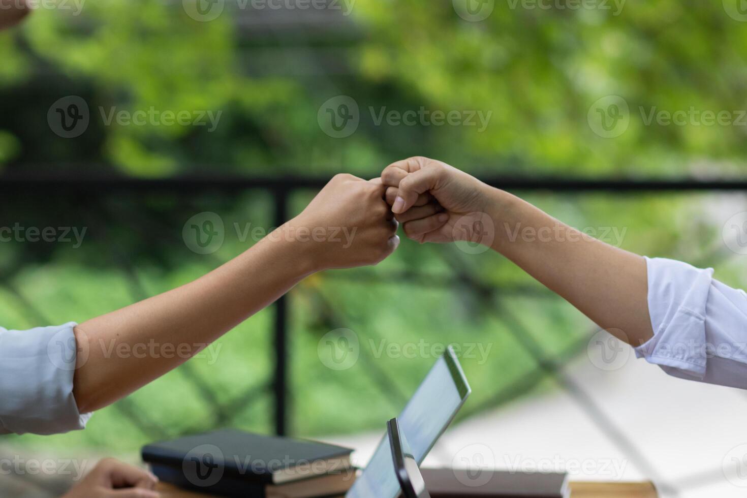 A woman uses her fist to greet each other during the coronavirus pandemic to help prevent the spread of the usual handshake. The concept of changing life to be a New Normal for safety. photo