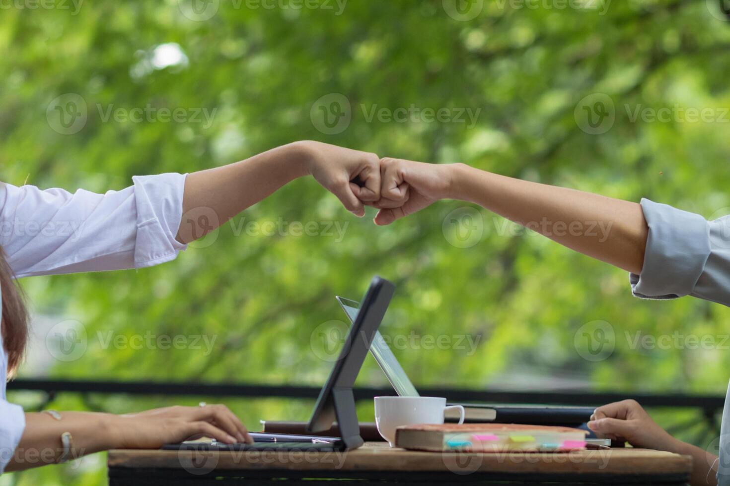 A woman uses her fist to greet each other during the coronavirus pandemic to help prevent the spread of the usual handshake. The concept of changing life to be a New Normal for safety. photo