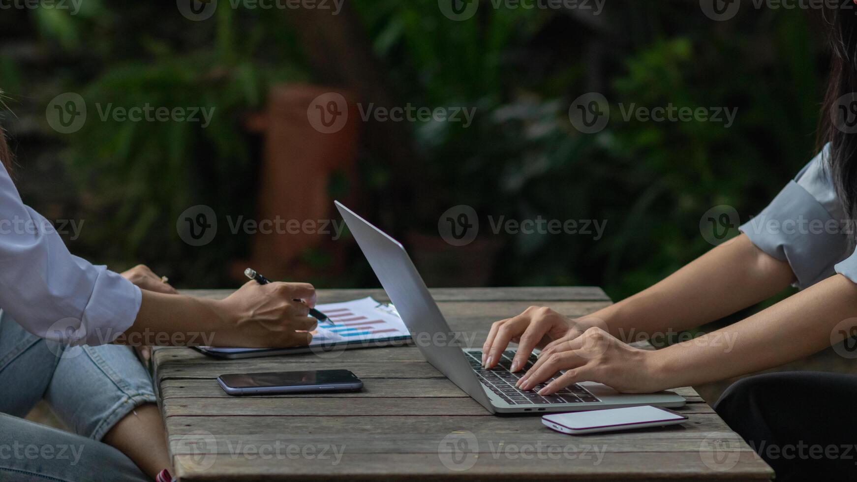 young businesswoman is reviewing results of corporate network via laptops and the Internet in order to prepare documents for meetings to give investors confidence in doing business. photo