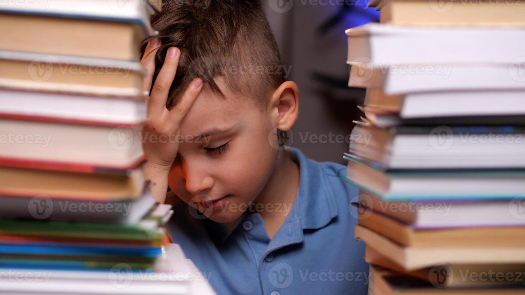 Young student feeling exhausted and stressed while studying photo