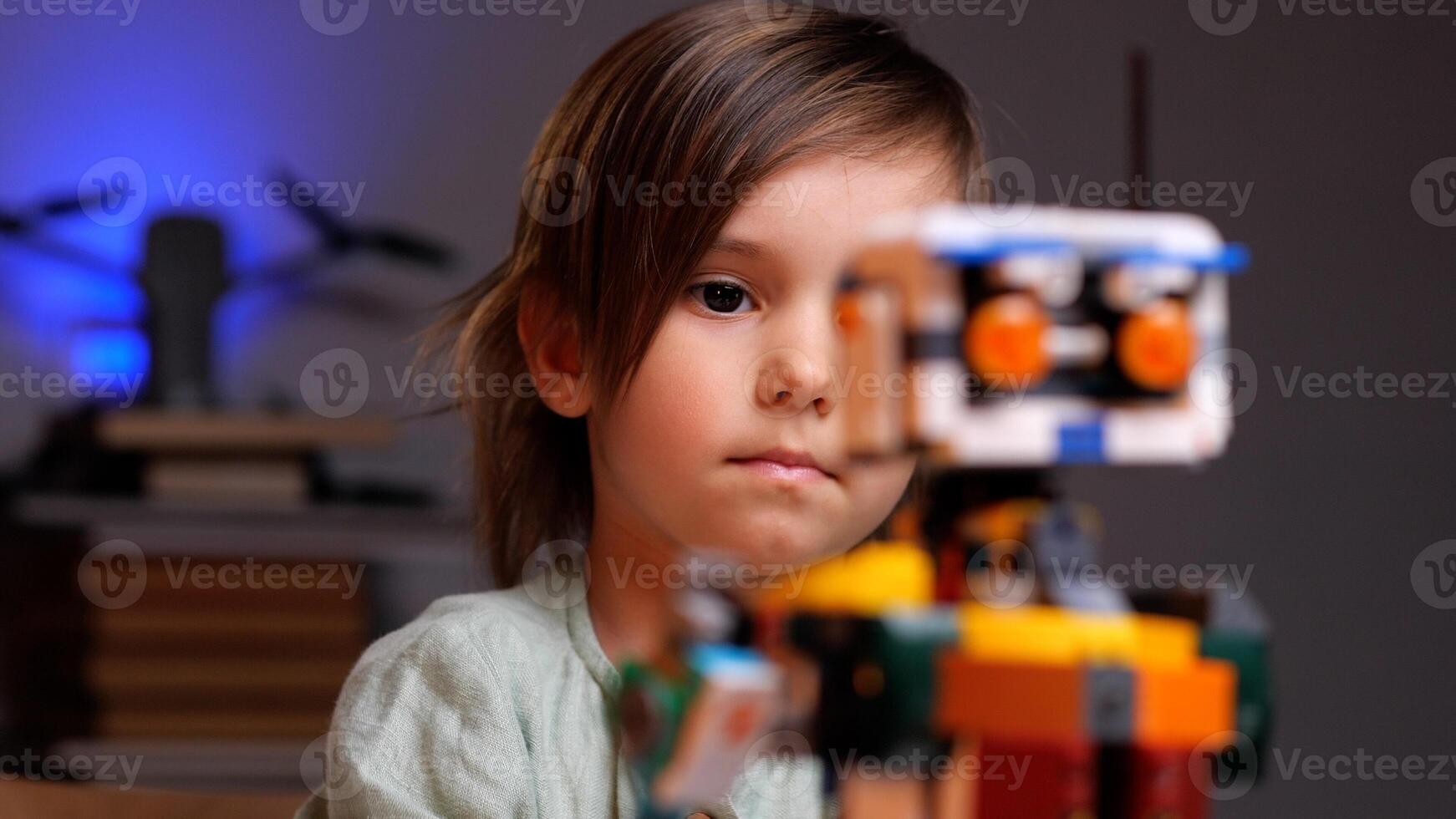 Young child building robotics project at home photo