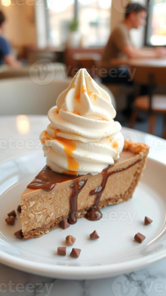 Closeup of a slice of chocolate pie with whipped cream and caramel sauce on a white plate photo