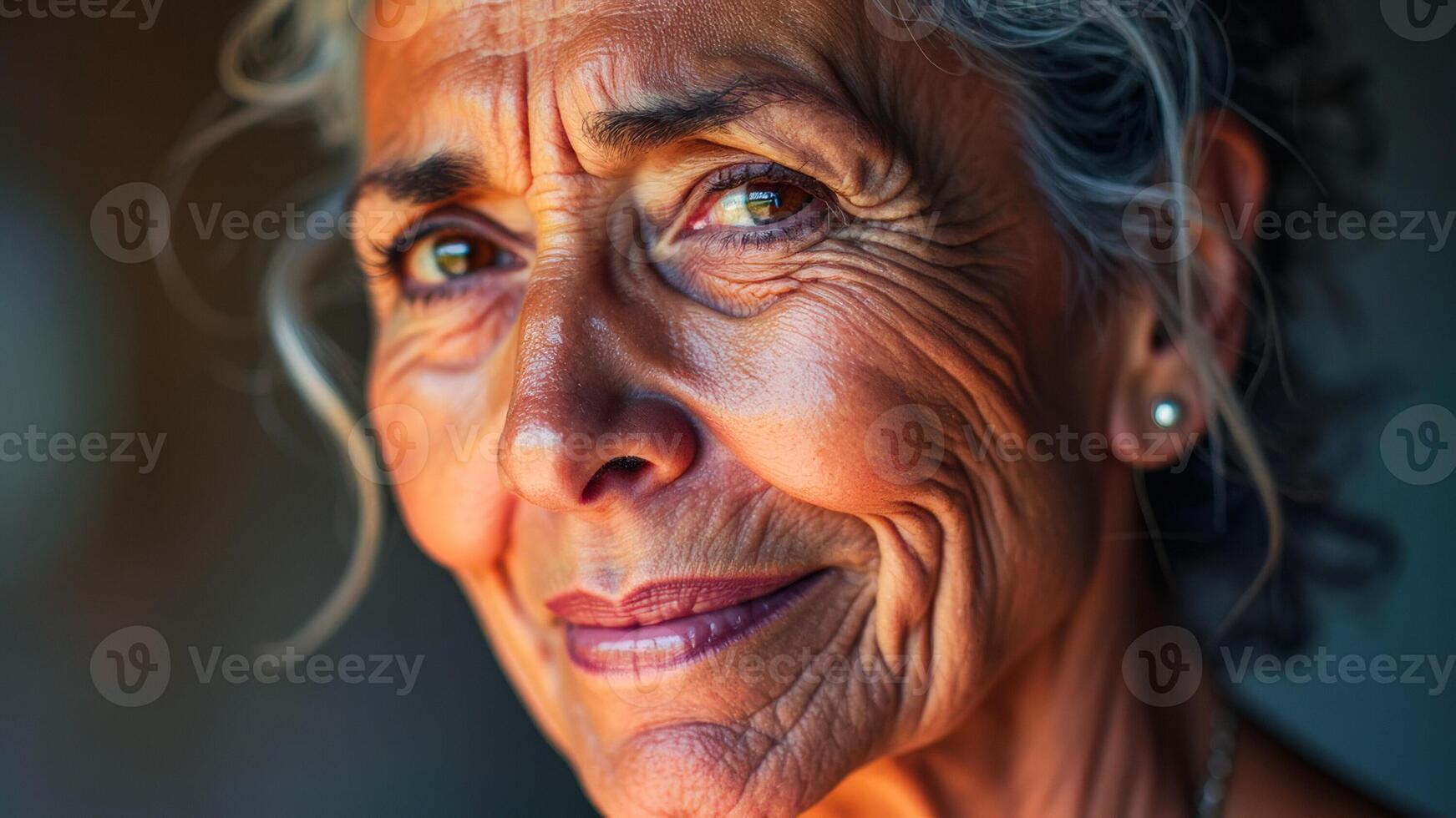Closeup portrait of a mature woman with wrinkles around her eyes and mouth, looking away from the camera photo