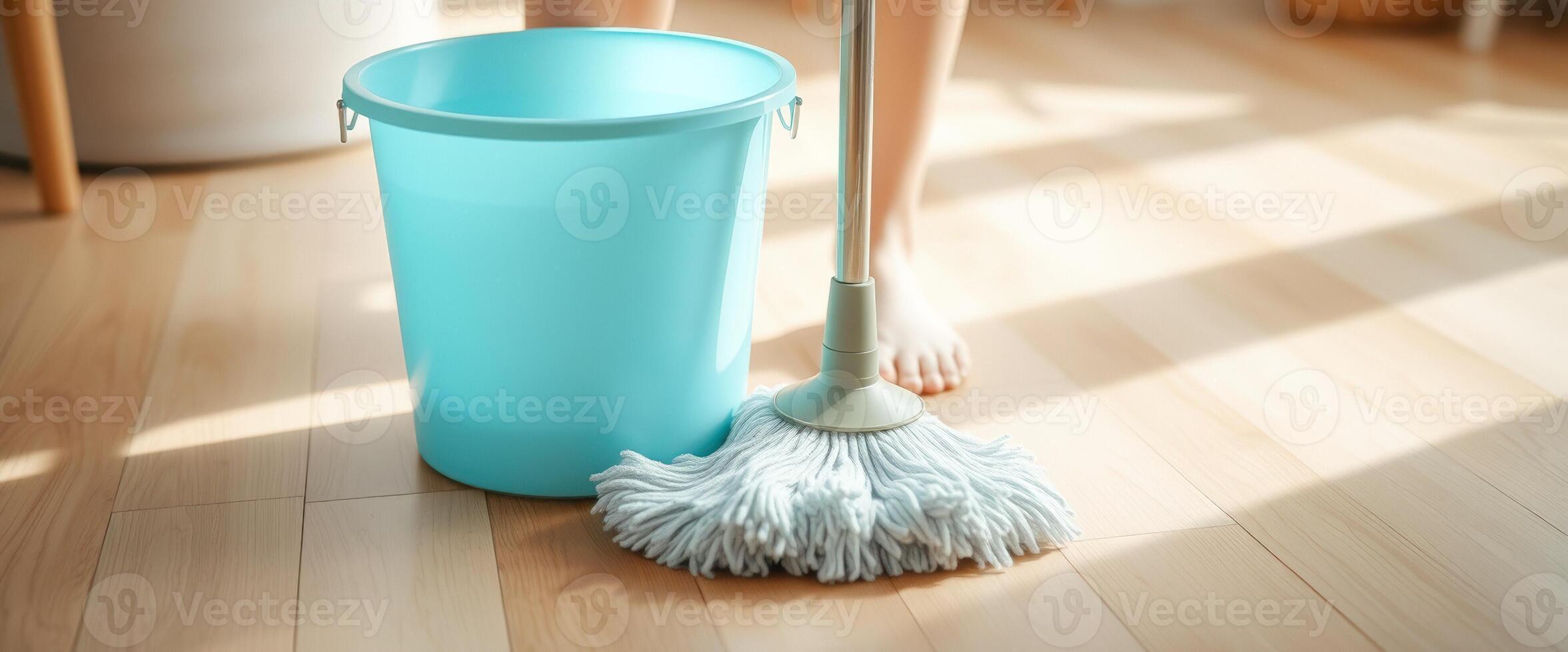 Close up of a mop and bucket on a wooden floor photo