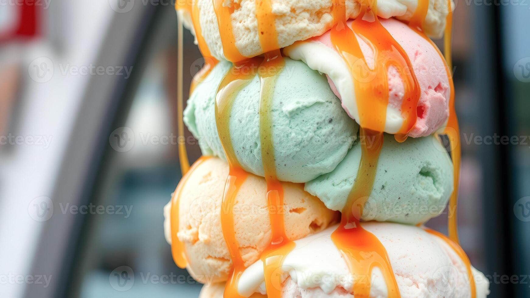Closeup of ice cream scoops drizzled with caramel sauce photo