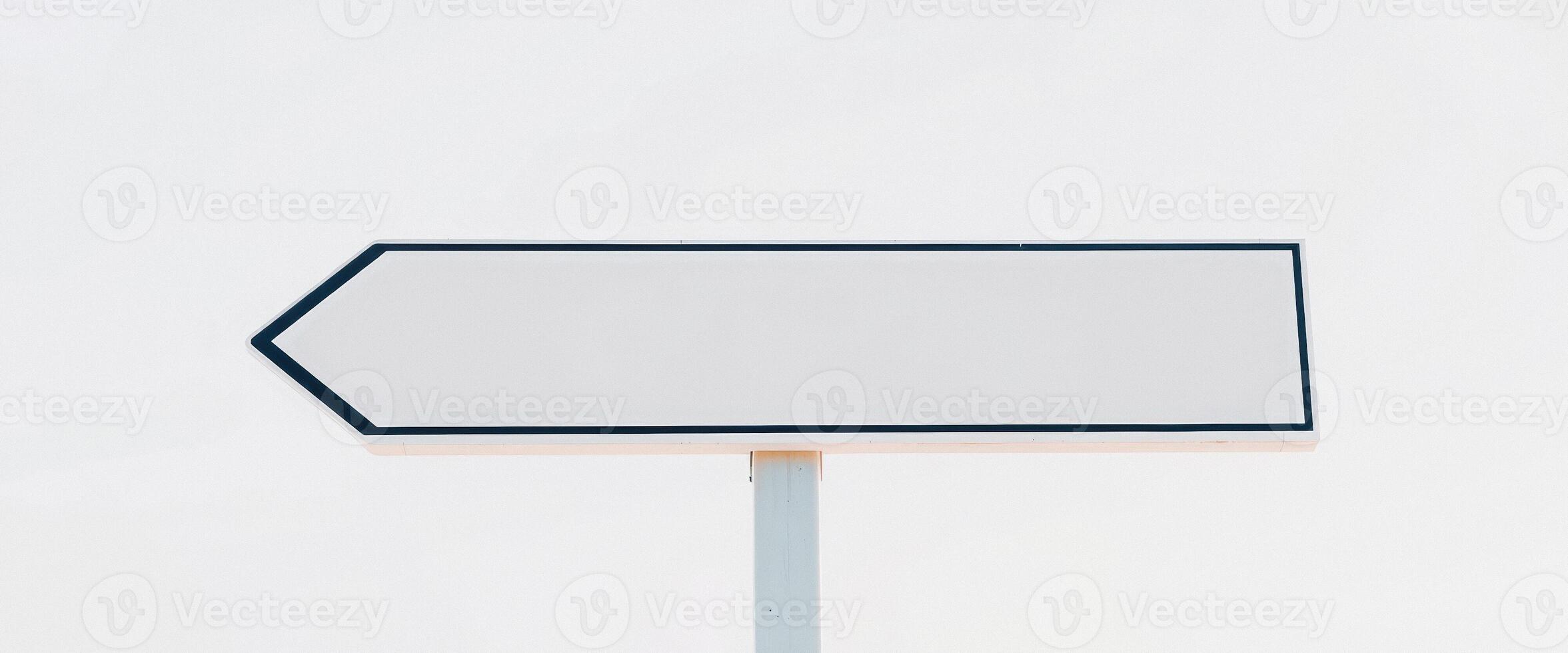 Blank White Signpost Against a Cloudy Sky photo