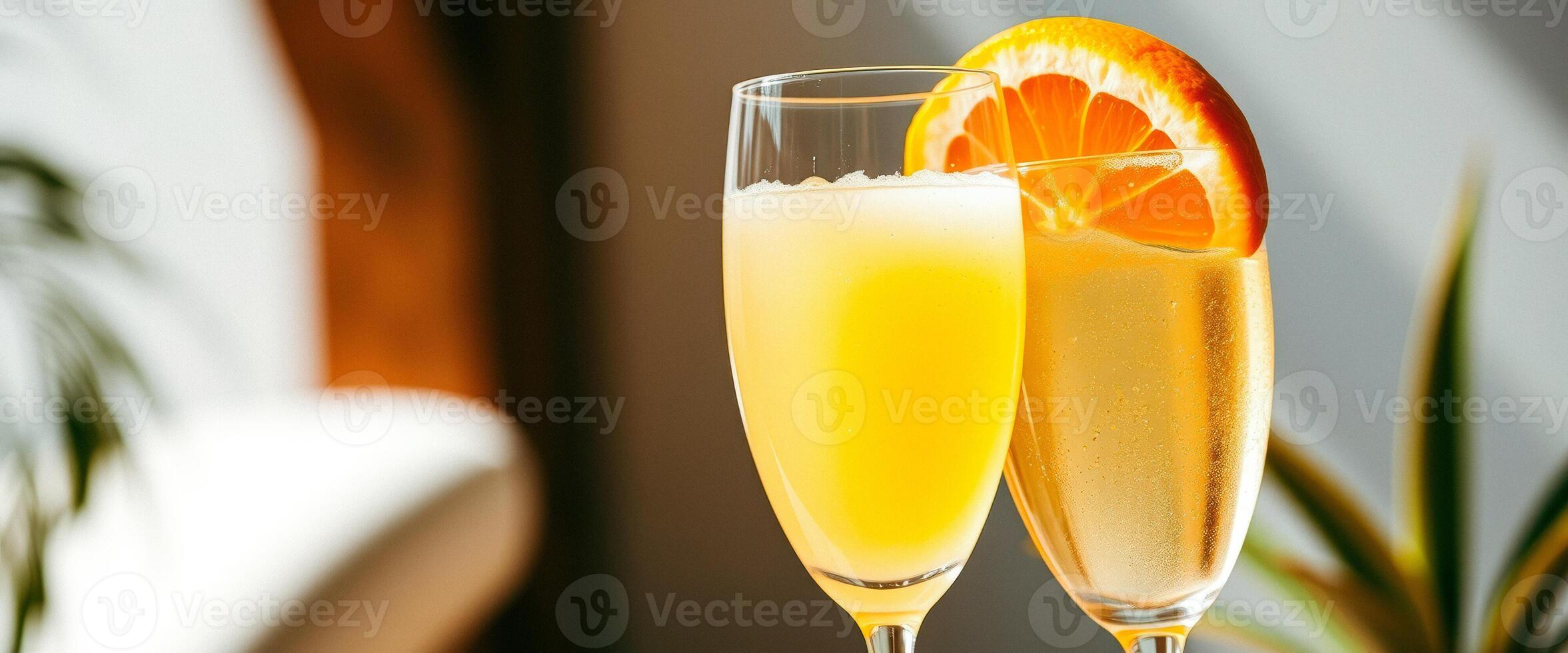 Two glasses of mimosa with orange slices photo