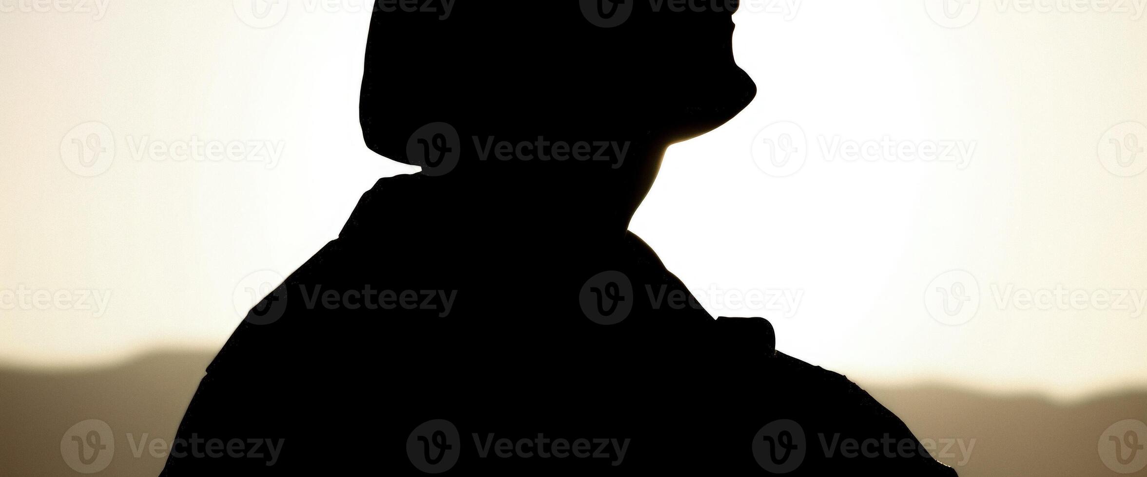 Silhouette of a Person Standing in Front of the Setting Sun photo